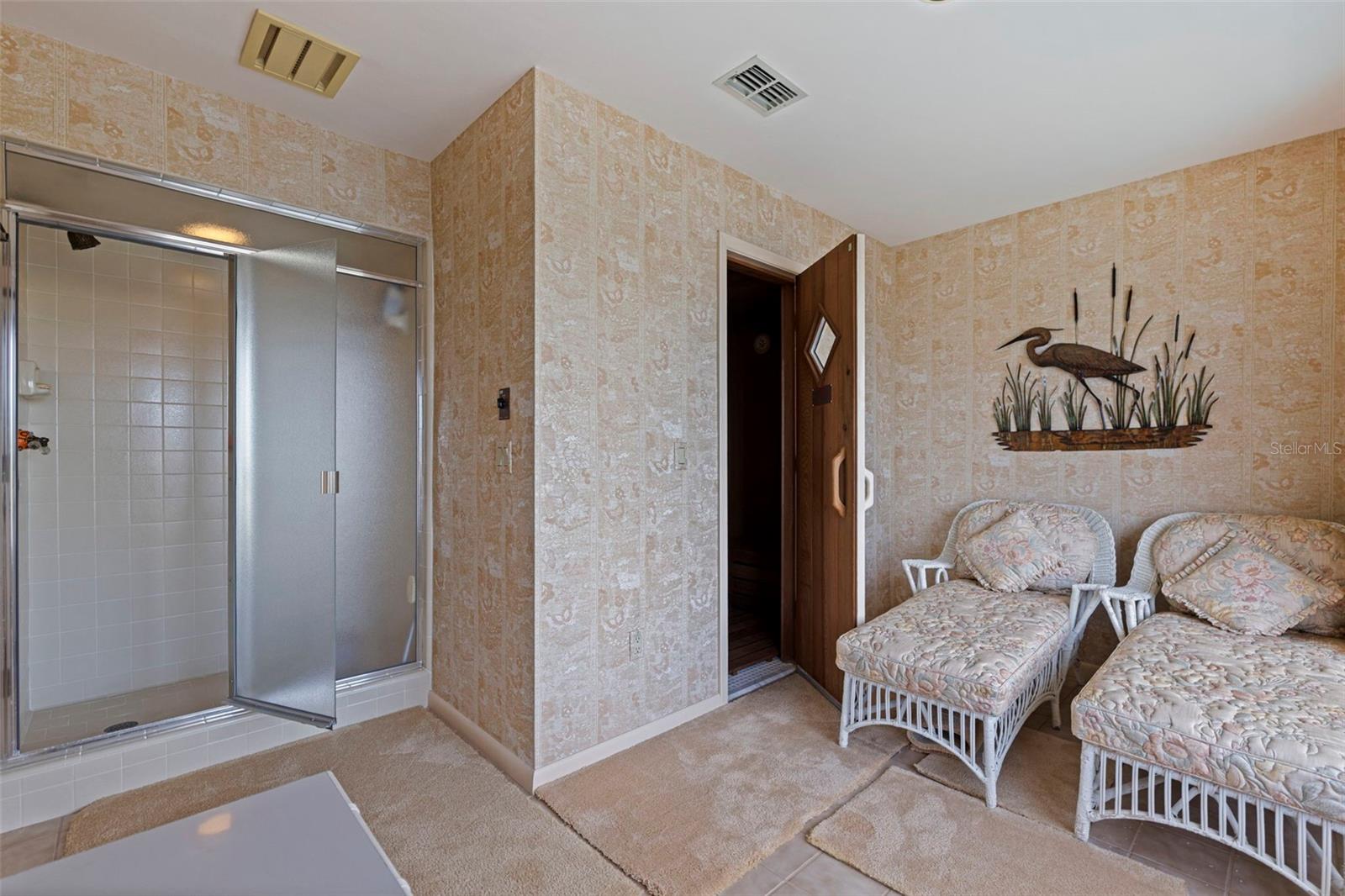 Shower and sitting area in the sauna room