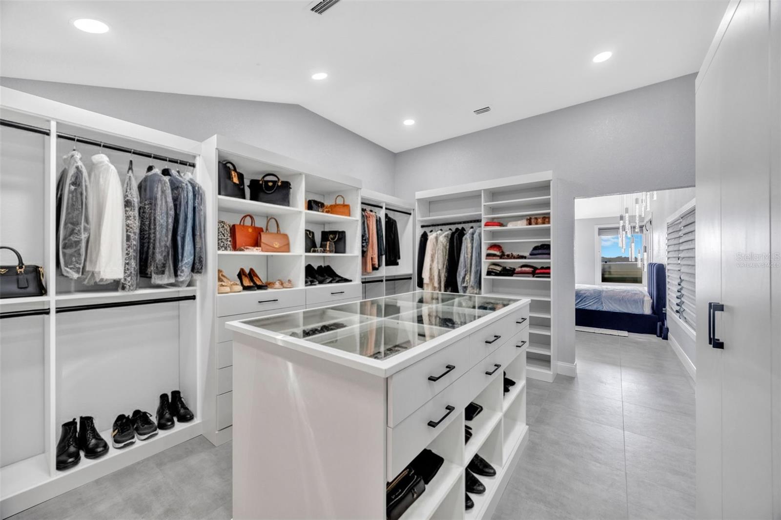 Primary Walk-In Closet This photo has been virtually staged
