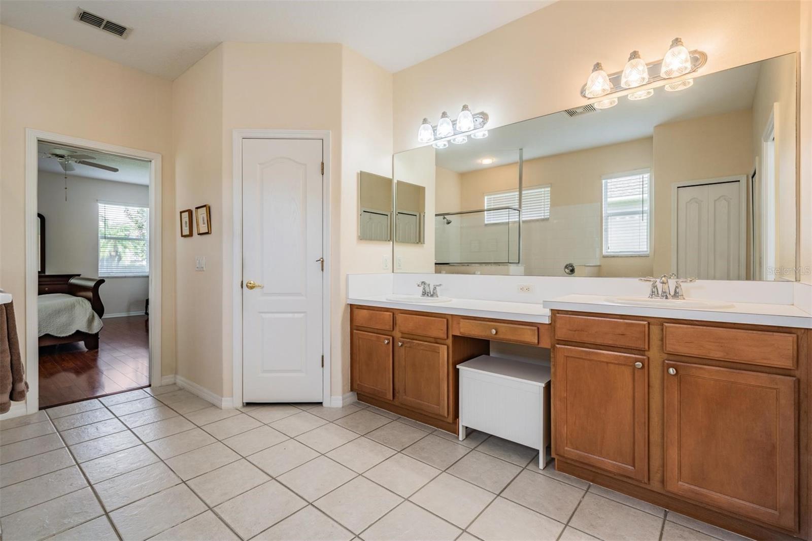 Expansive primary bathroom with linen closet