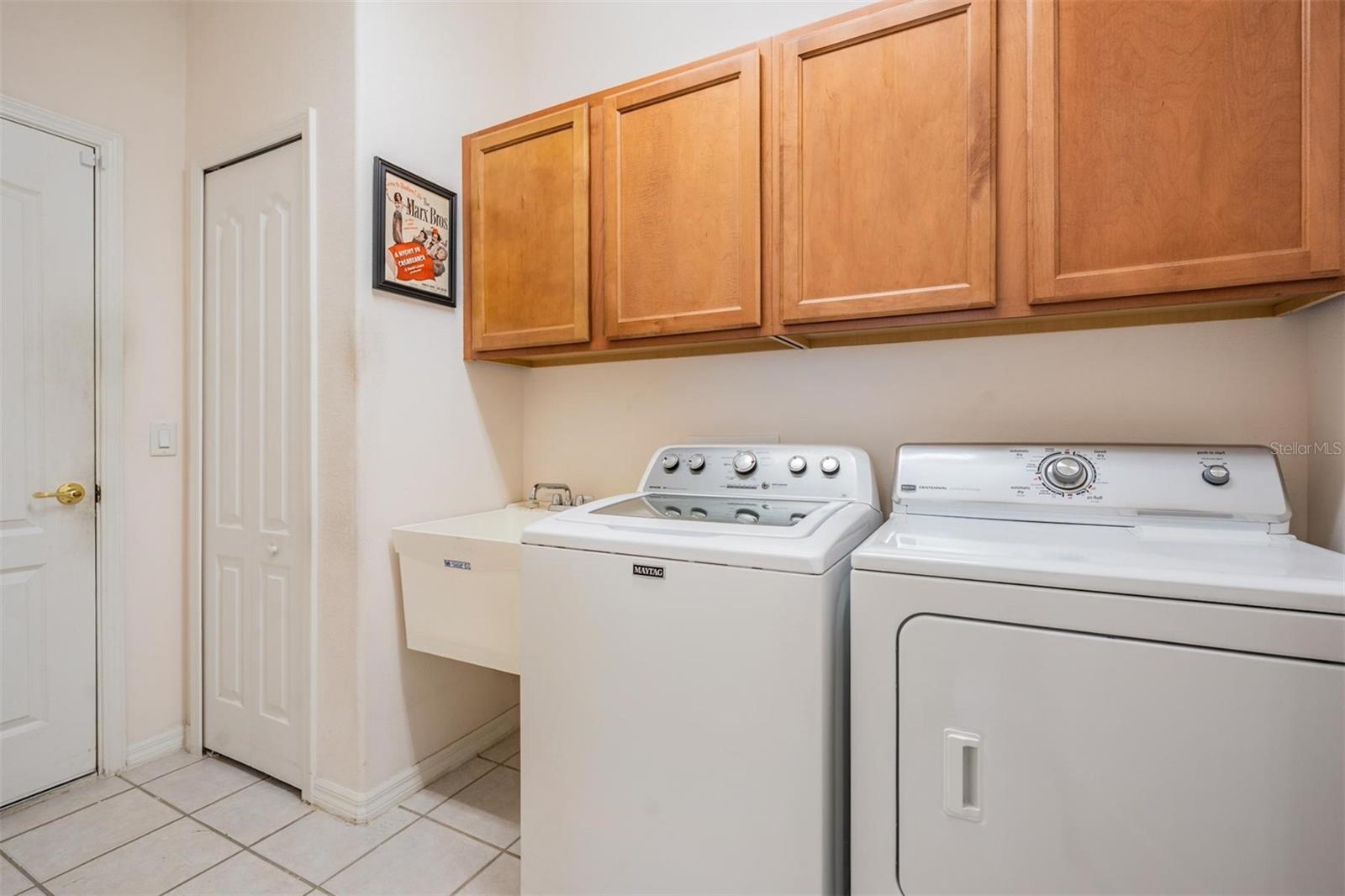 Walk-in laundry room with additional storage