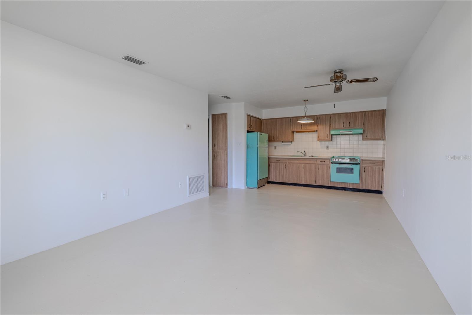 Step inside to a bright and open living space that seamlessly blends the living, dining, and kitchen areas into one flexible layout—perfect for easy Florida living.