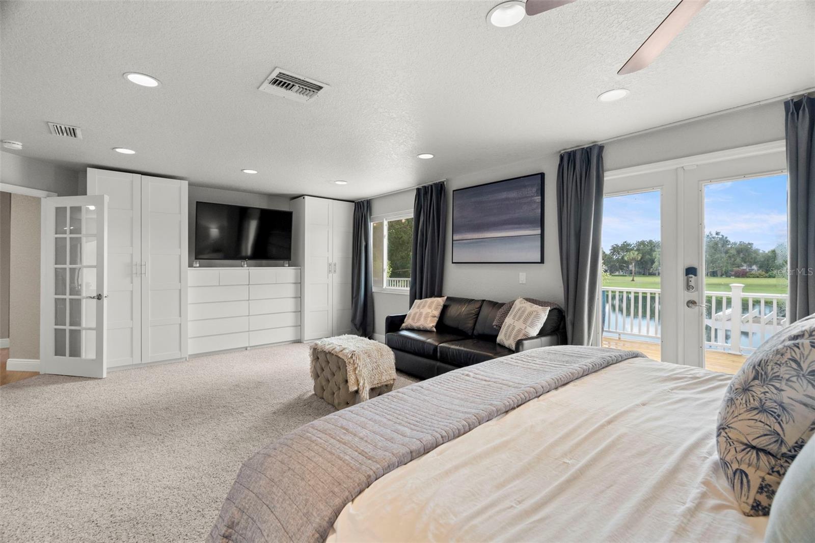 Peaceful primary ensuite with French doors doors to new balcony