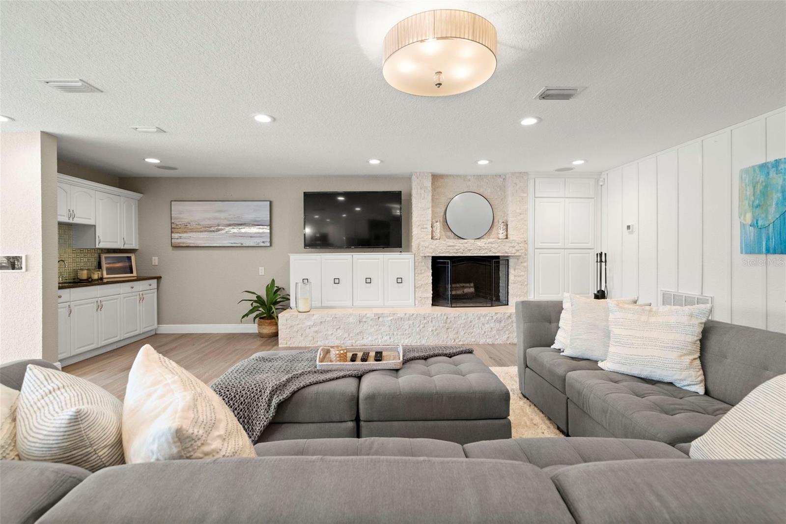 Family room with built-in storage and wood burning fireplace