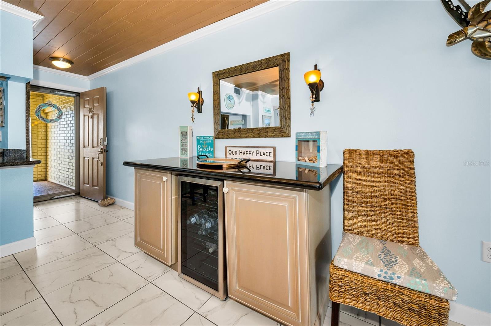 An elegant beverage station anchors the living area—perfect for cocktail hour, morning brews, and effortless hosting