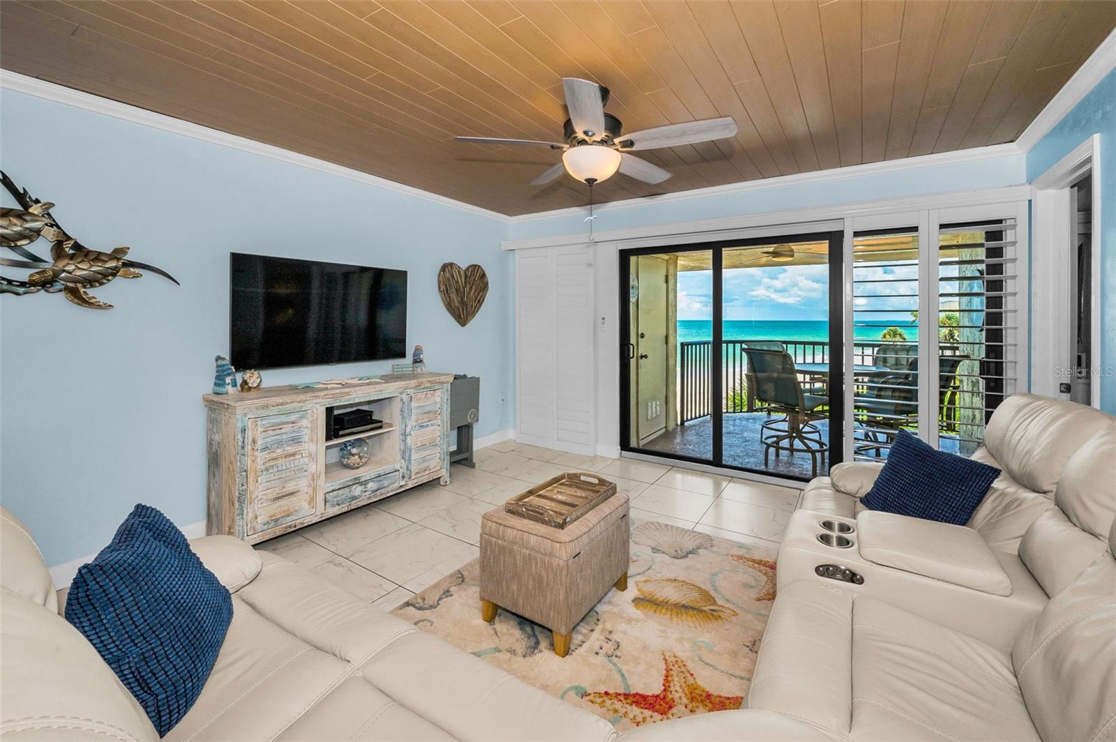 Sophisticated yet relaxed, this waterfront-facing living area invites natural light, fresh air, and endless inspiration
