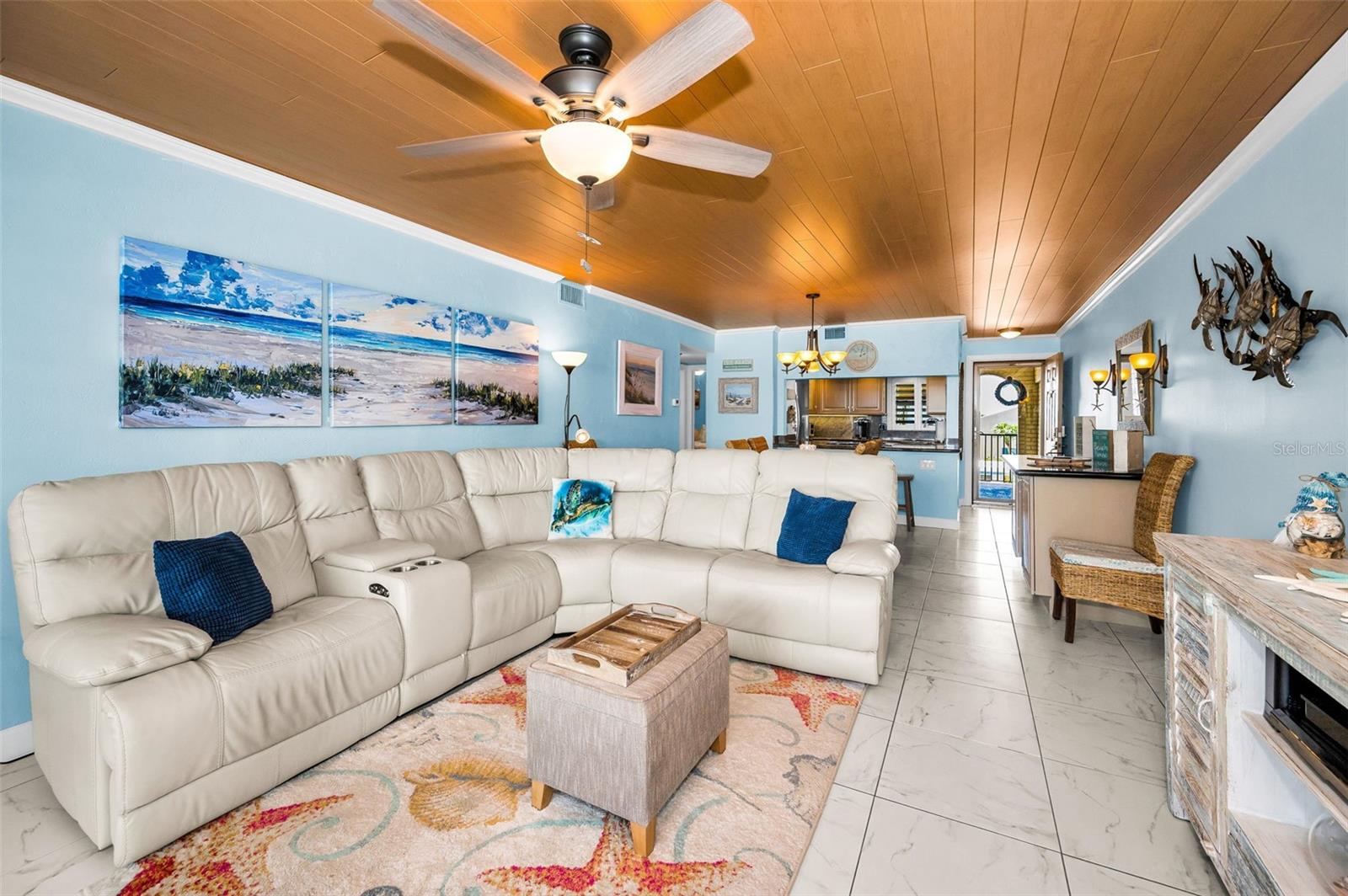 Timeless and tactile, the beamed shiplap ceiling sets the tone—crisp lines, coastal charm, and a breezy, elevated feel