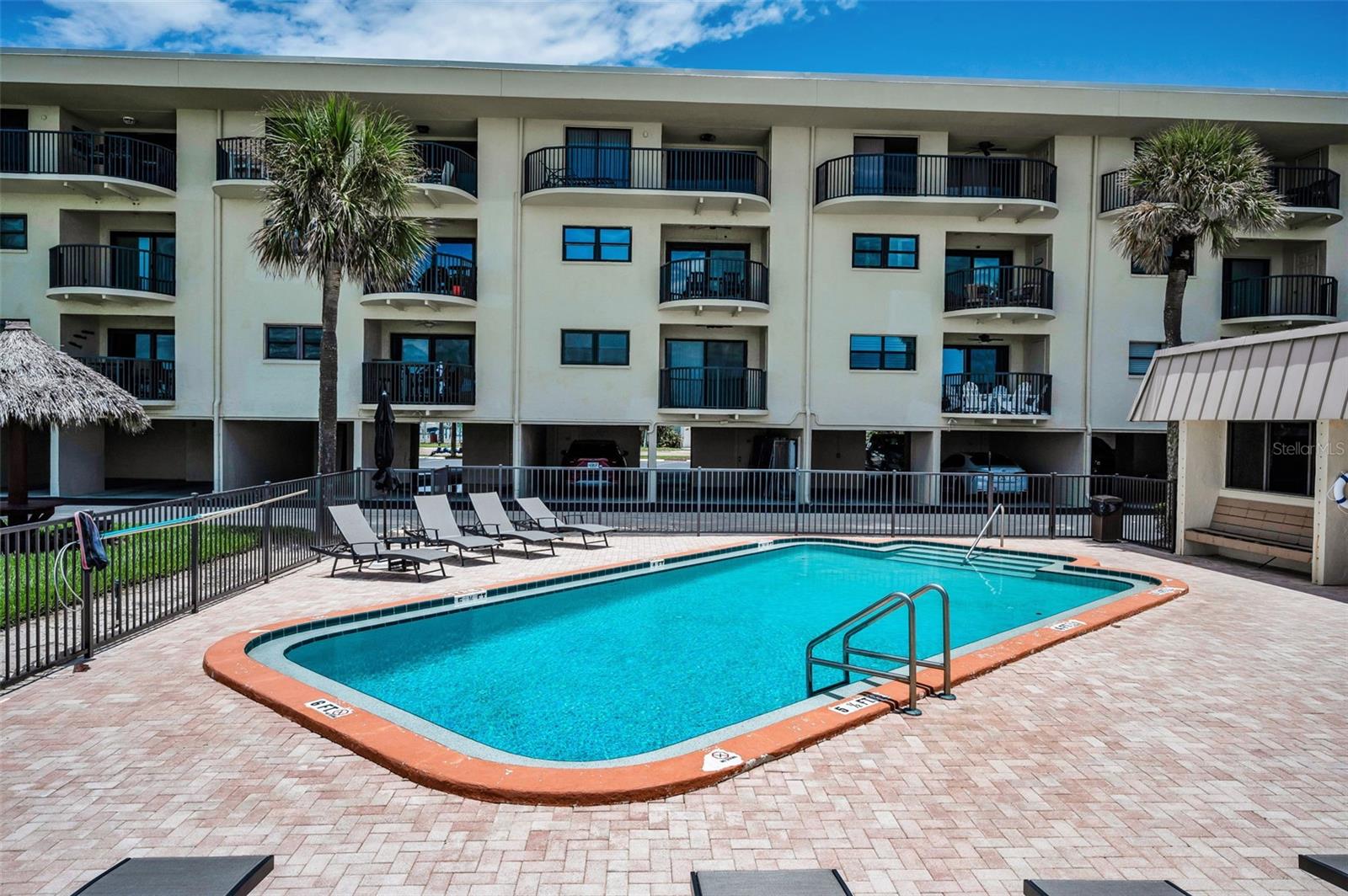 Sun, sea, and a shimmering escape—this beachfront inground pool offers resort-level luxury just steps from the sand.