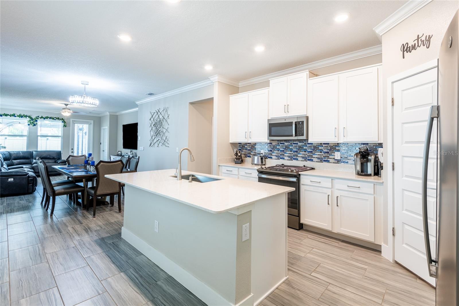 Open floor plan! Shaker wood cabinets, quartz countertops and stainless appliances. Large island room for barstools.