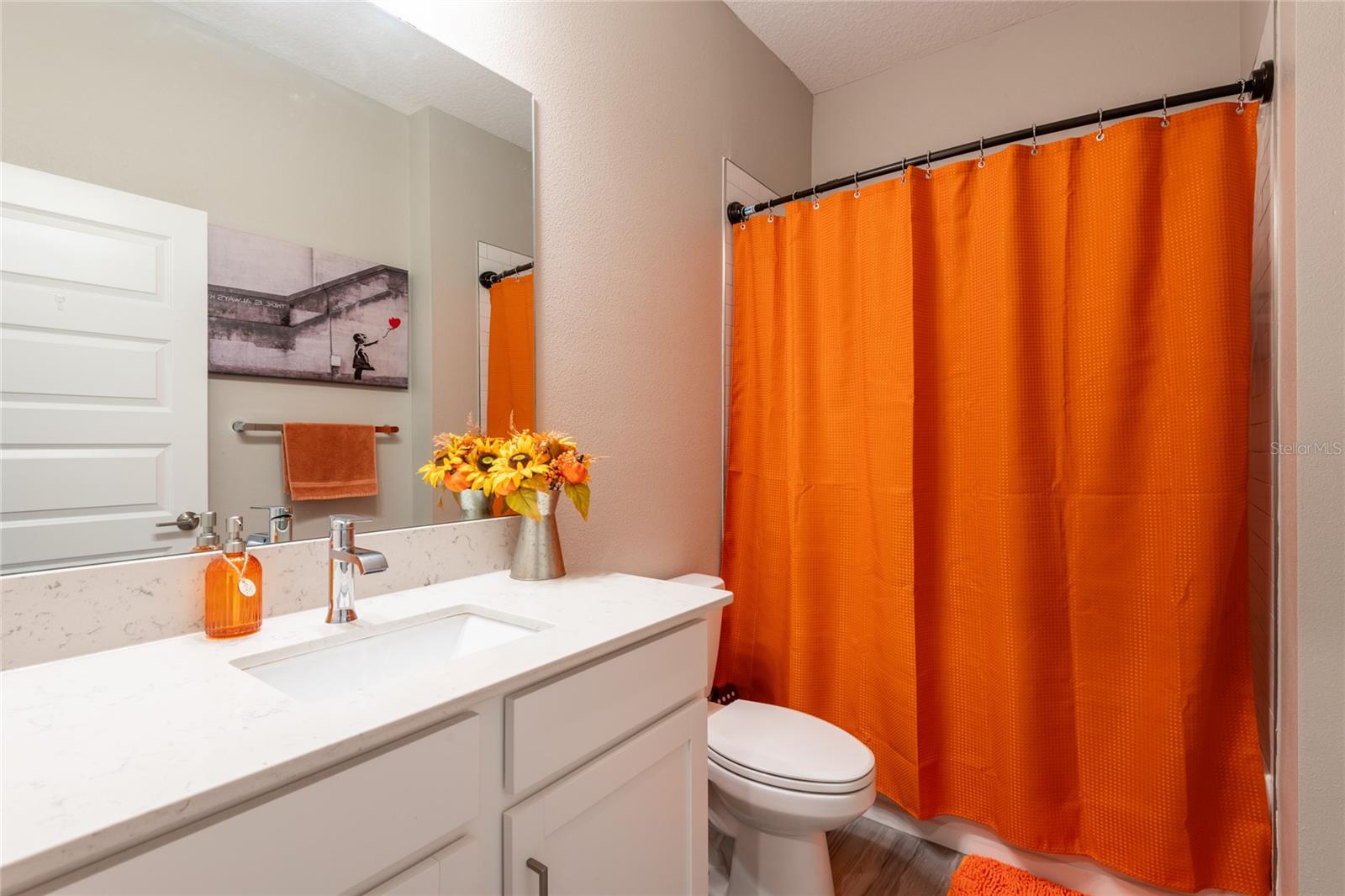Large second bathroom with tub.