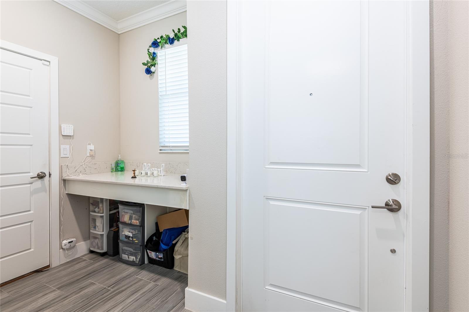 Storage area by front door/garage door. Great for backpacks/purses etc.