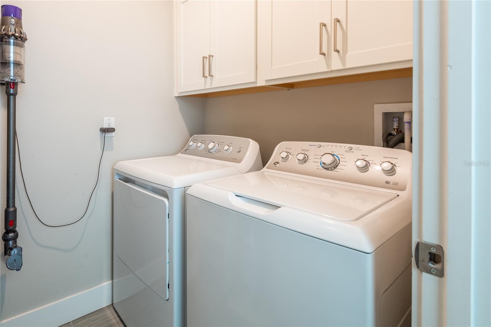 Laundry room with storage. Washer and dryer will be left for new buyer.