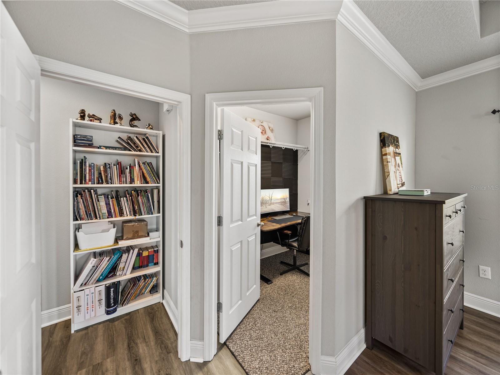 Off the primary room is a second closet, currently being used as an office