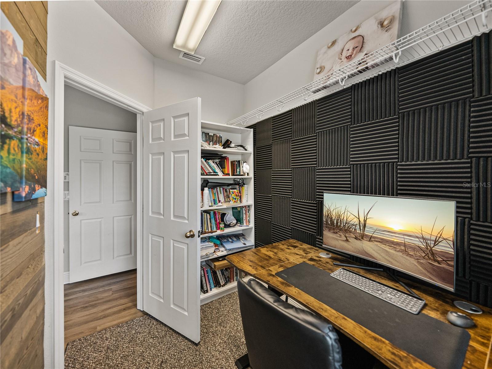 Off the primary room is a second closet, currently being used as an office