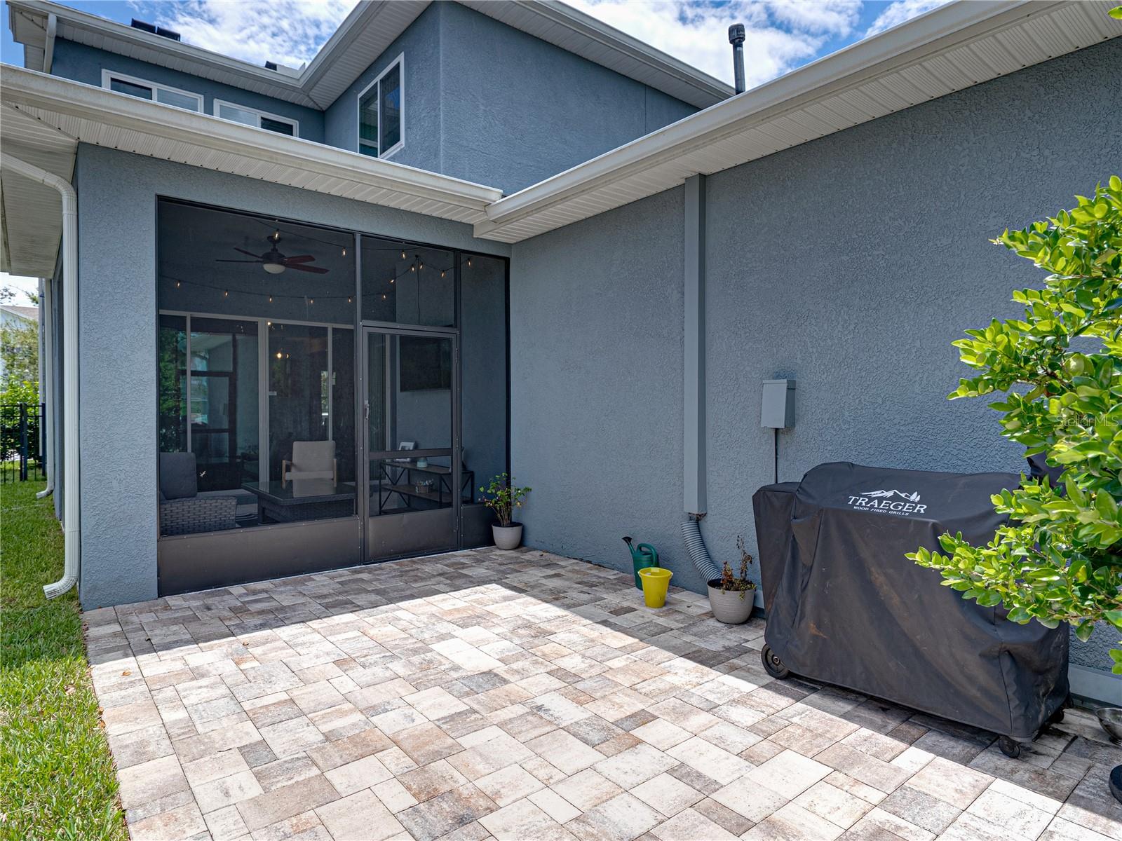 Paver patio is just beyond the screened lanai
