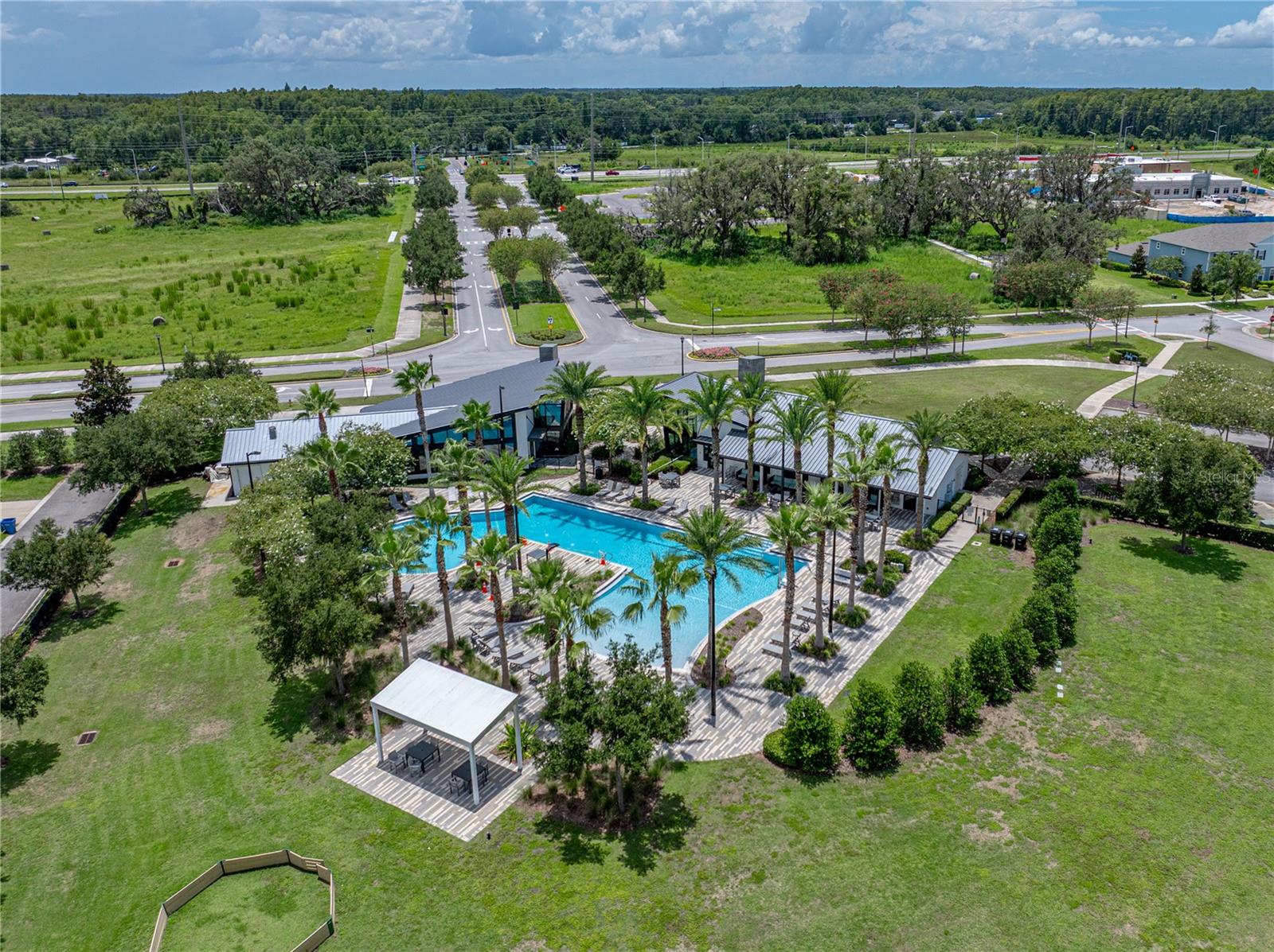 Asturia clubhouse and pool with SR 54 in the distance.