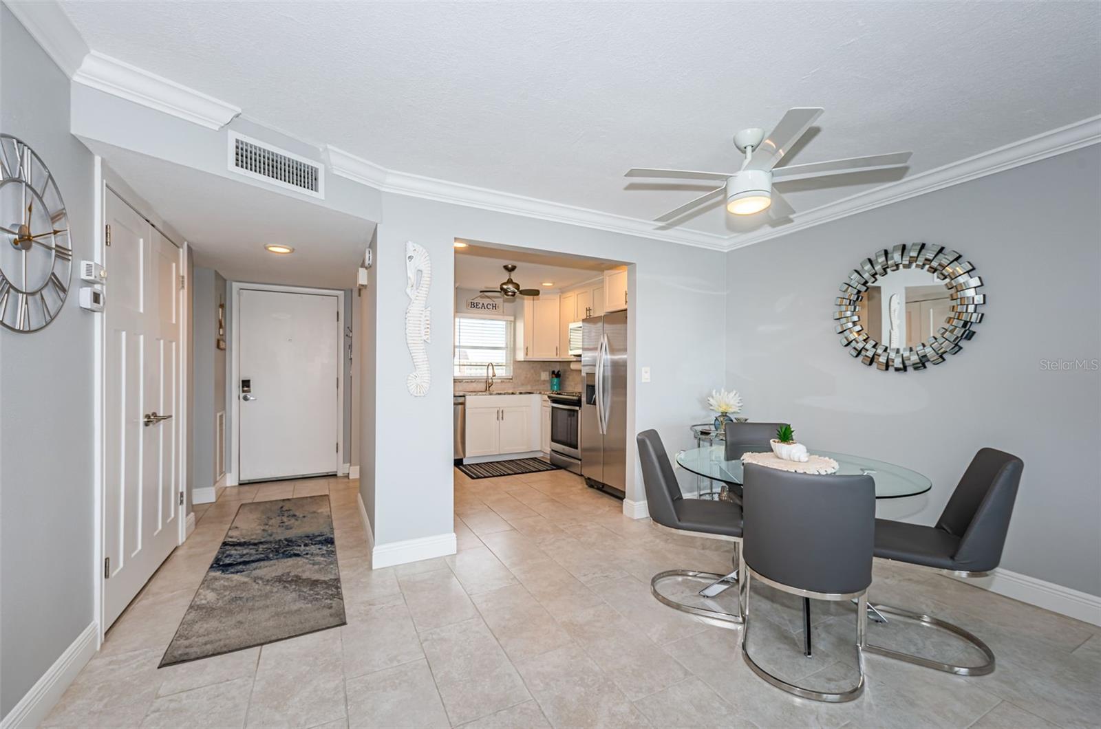 Dining room - neutral color porcelain tile through-out the condo