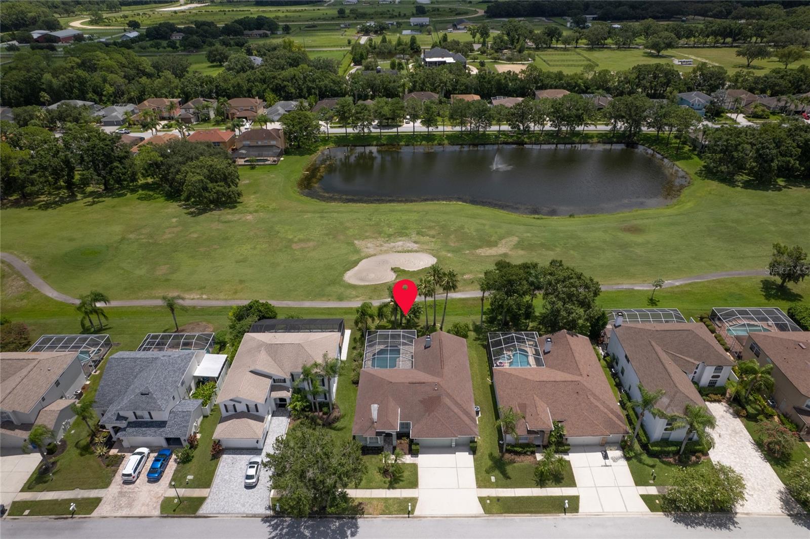Aerial view of this golf course and water view home