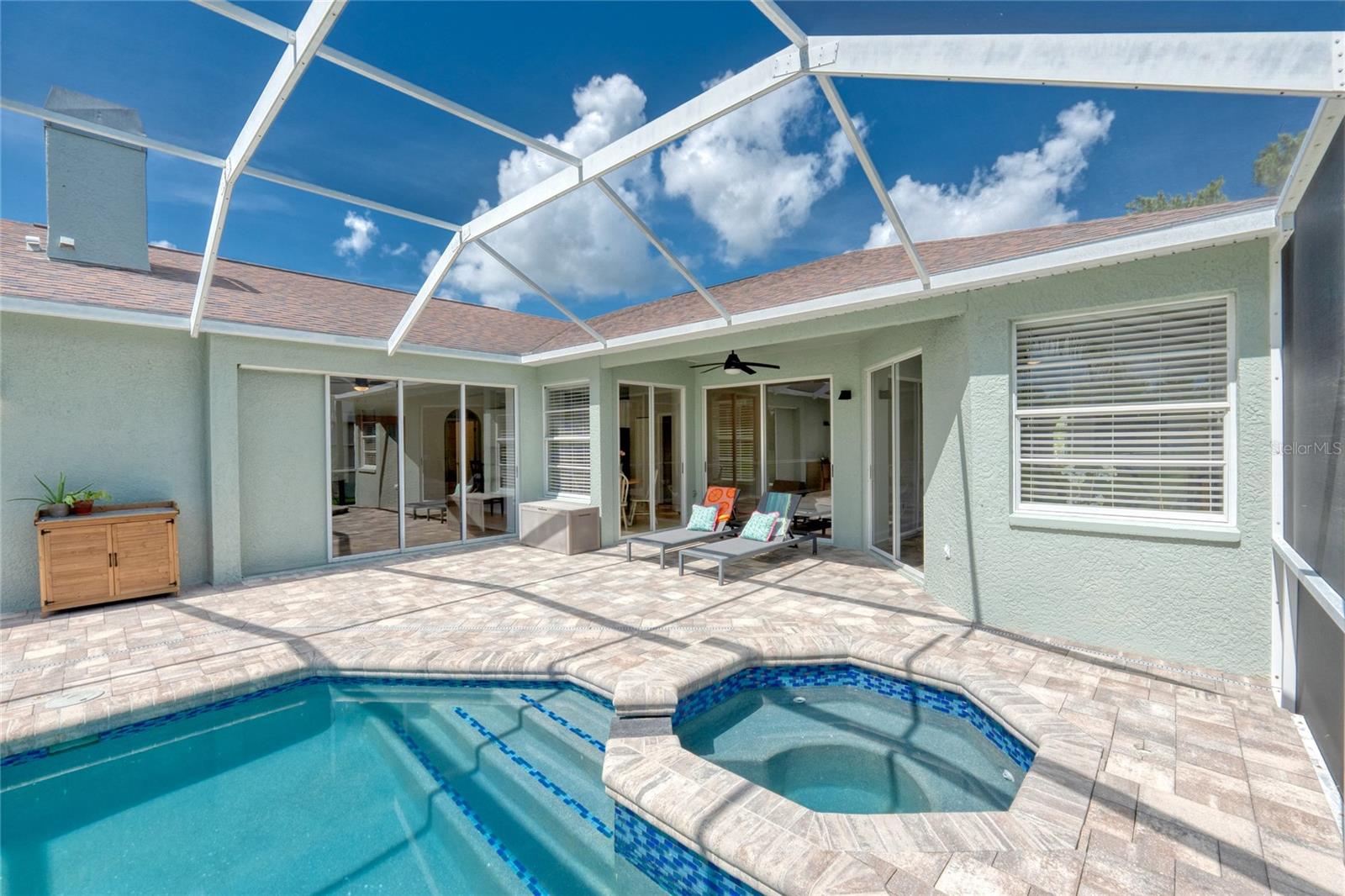 Pool and spa with a gorgeous paver deck