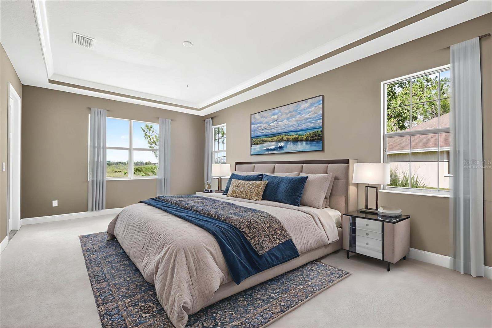 Virtually staged- primary suite with tray ceiling, backyard views, ample light.