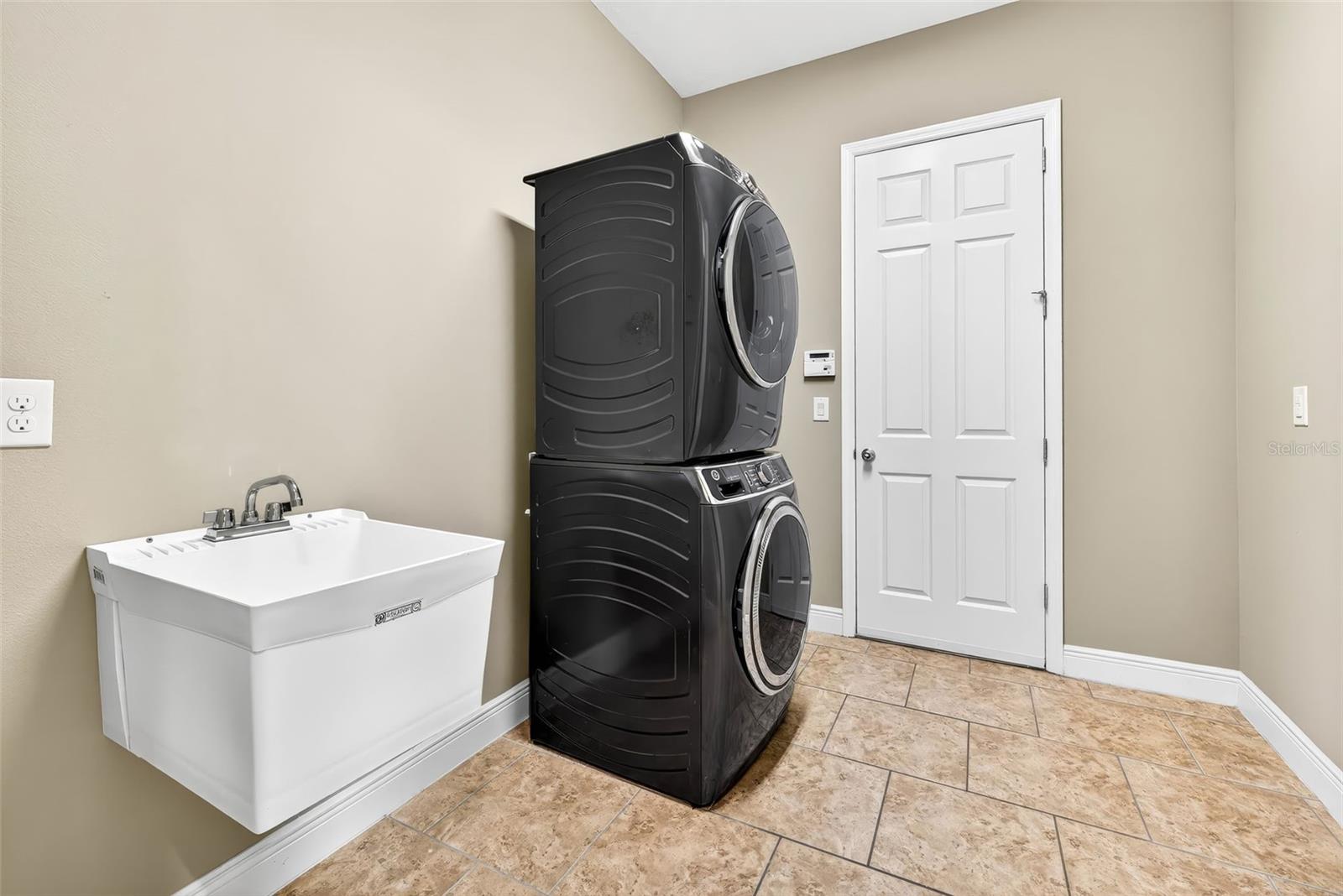 Laundry room with sink & leads to 3 car garage