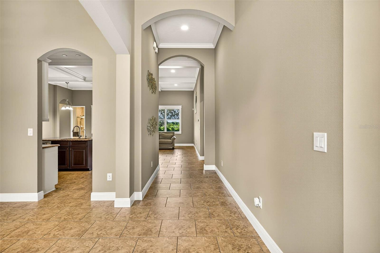 Archways throughout, extended baseboards and crown moulding.