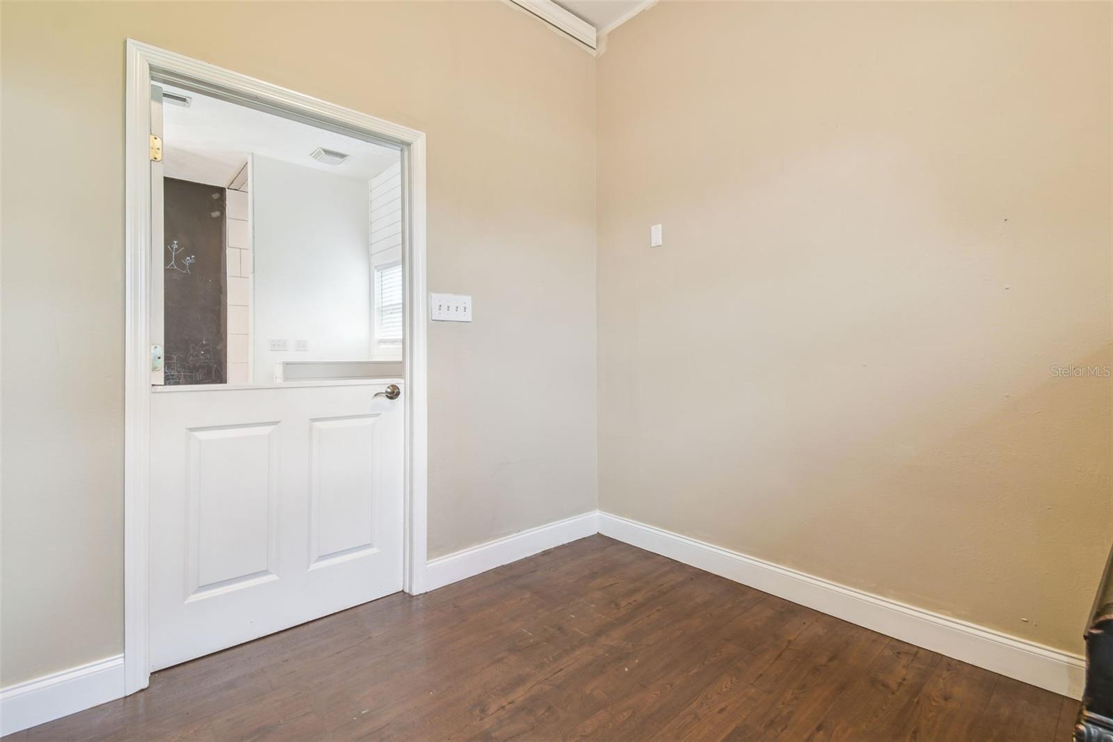 Dutch door entry to hall bath in main home from the loft through the mud room