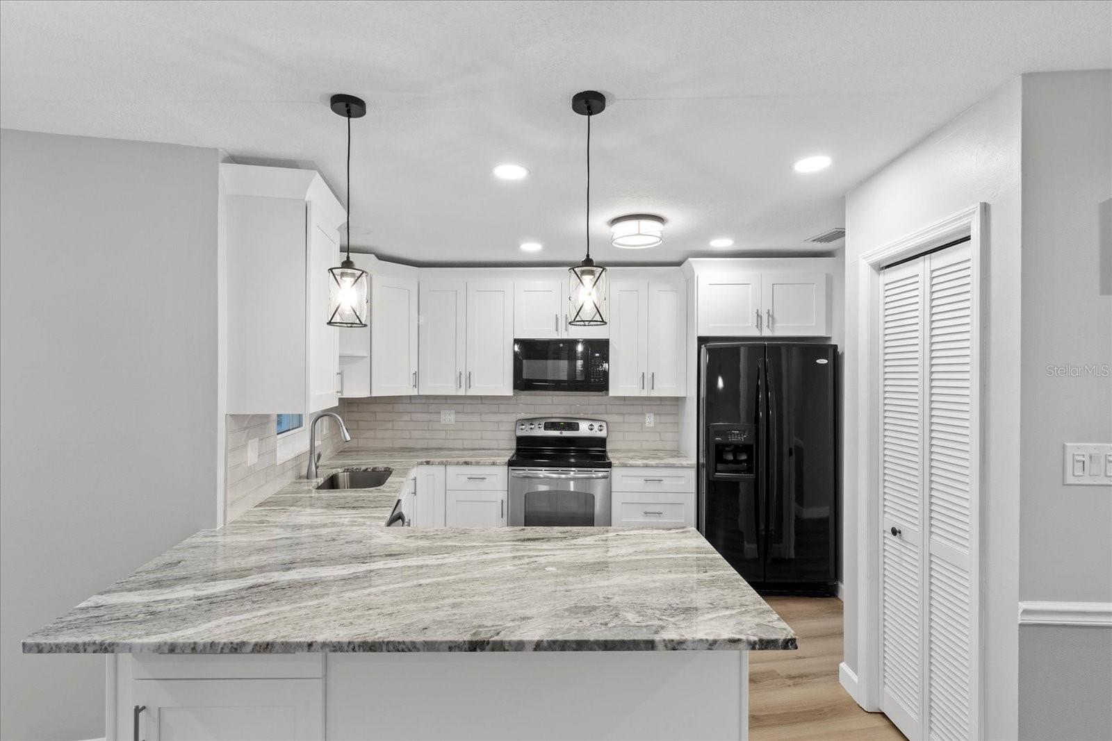Updated kitchen with granite. Pantry on right
