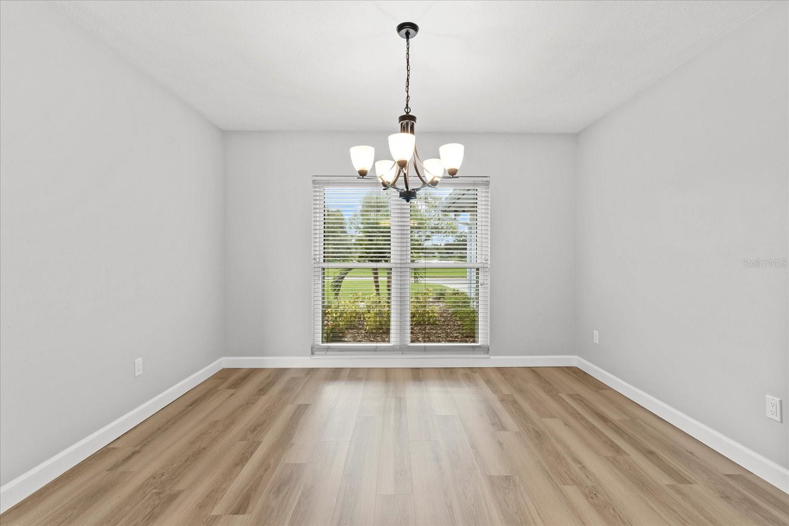 Dining room with view of front gardens and lake across street