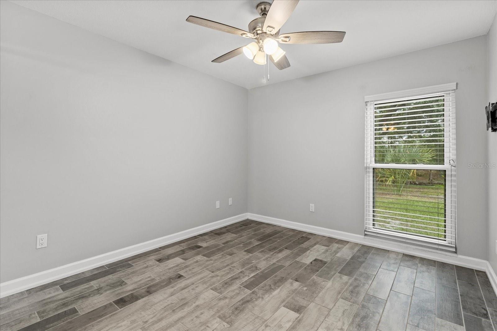 Guest bedroom #1 with view of back yard and lake
