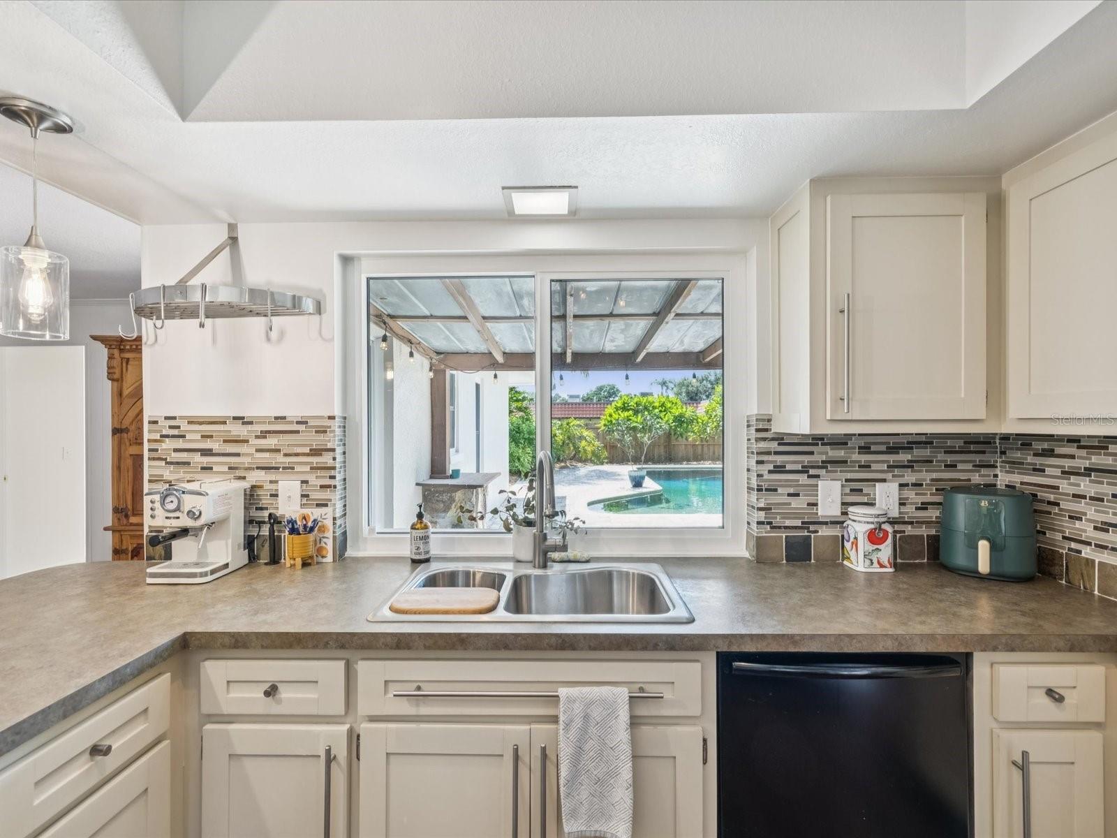 Kitchen w/ Large Window overlooking the Pool