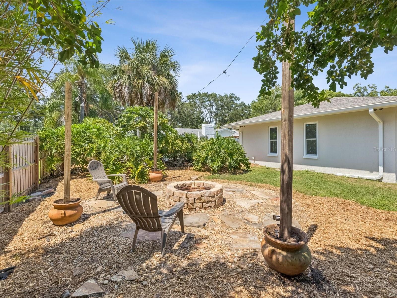 Backyard w/ Firepit looking towards the Pool Area