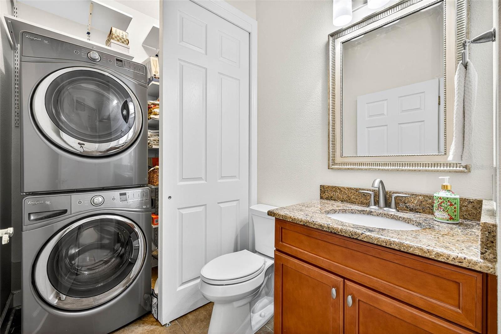 Interior laundry closet located in half bath