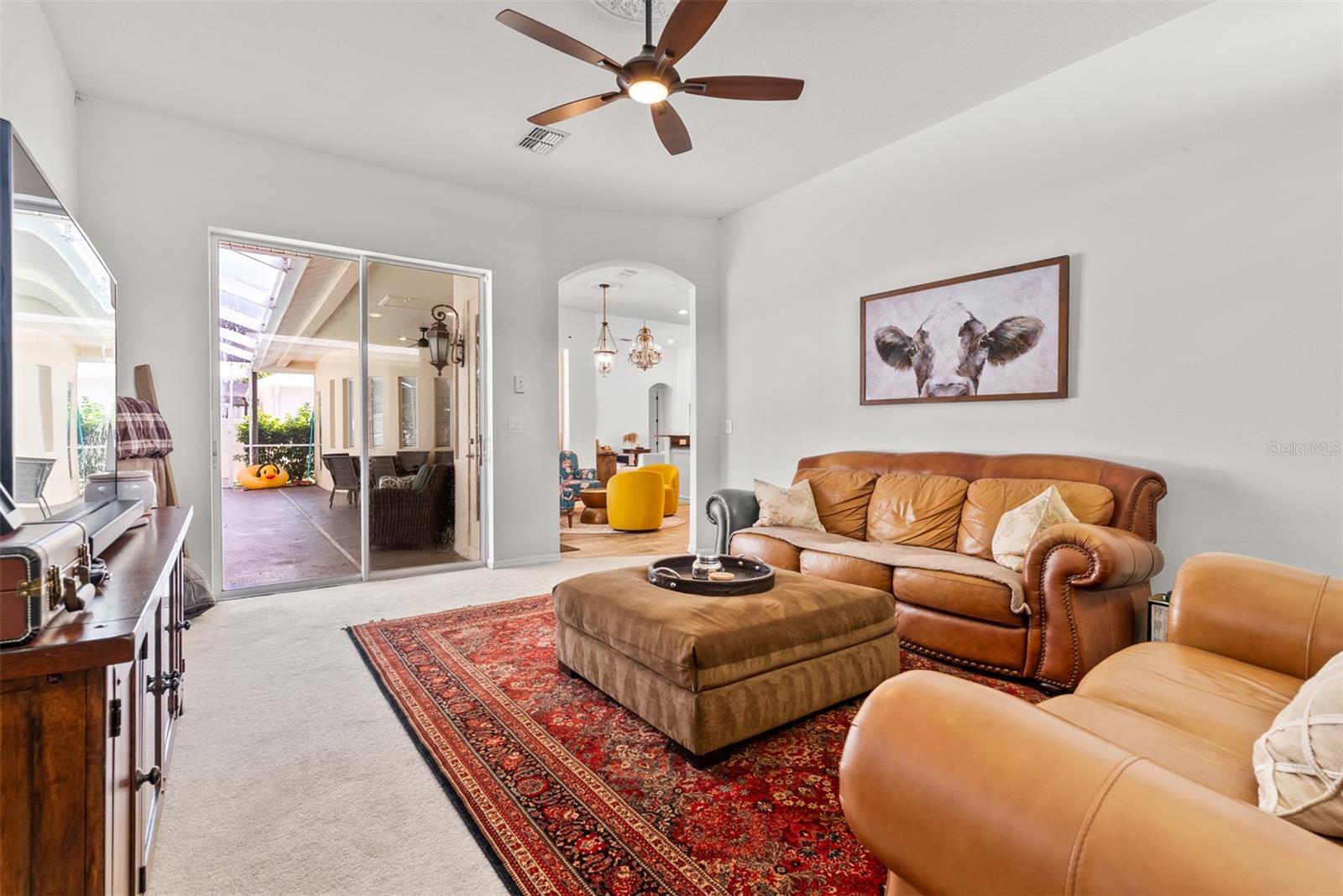 Family room opens to  lanai and pool