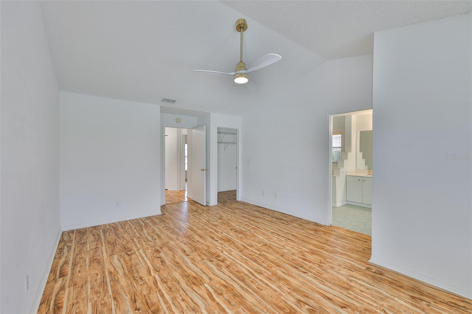Primary bedroom, hall center, walk-in closet with built-in cabinets center right, primary ensuite bath right.