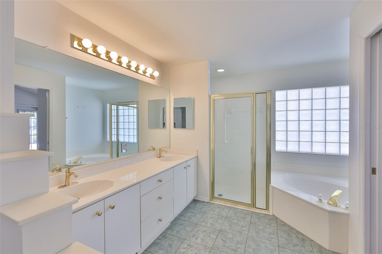 Primary bath, cabinets and drawers, new faucets, large stall shower, garden tub, glass block for privacy! And a bidet too!