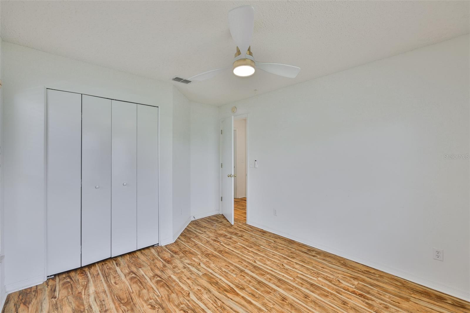Bedroom 2, folding door closet. New ceiling fan.