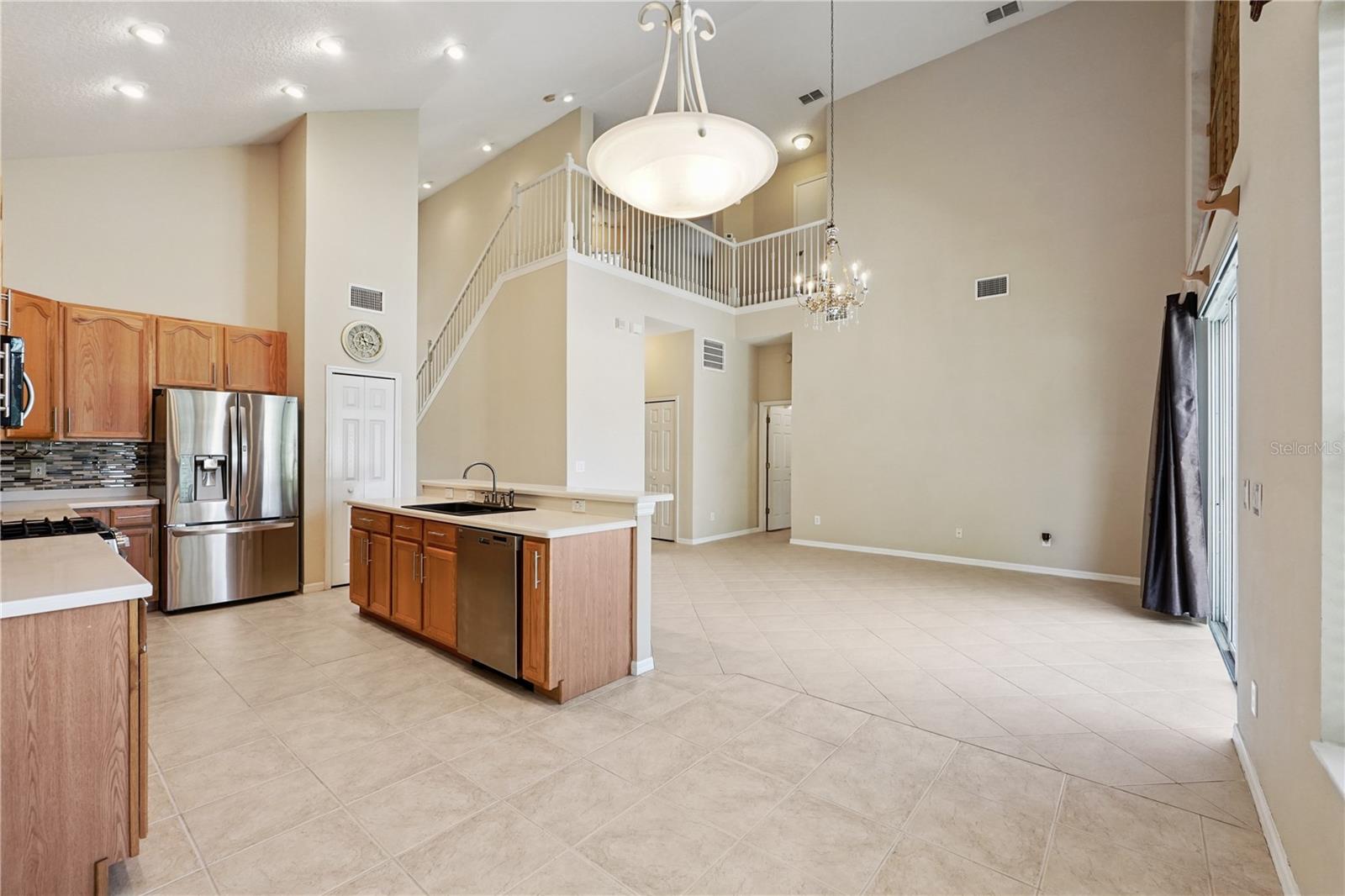 Family room, kitchen, and dinette with vaulted ceiling and lots of natural light.