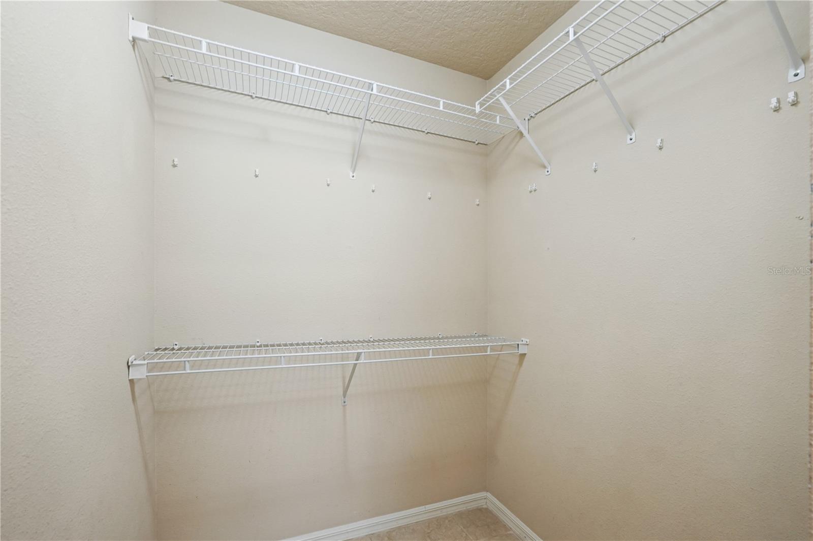 Primary bedroom walk-in closet