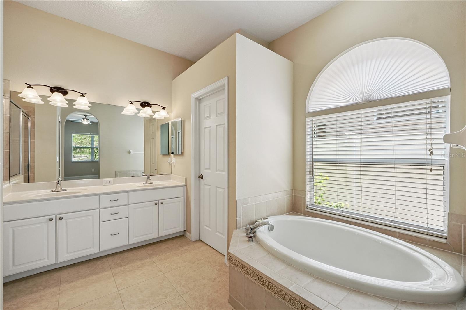 Primary bathroom with dual sink vanity and stand-up shower