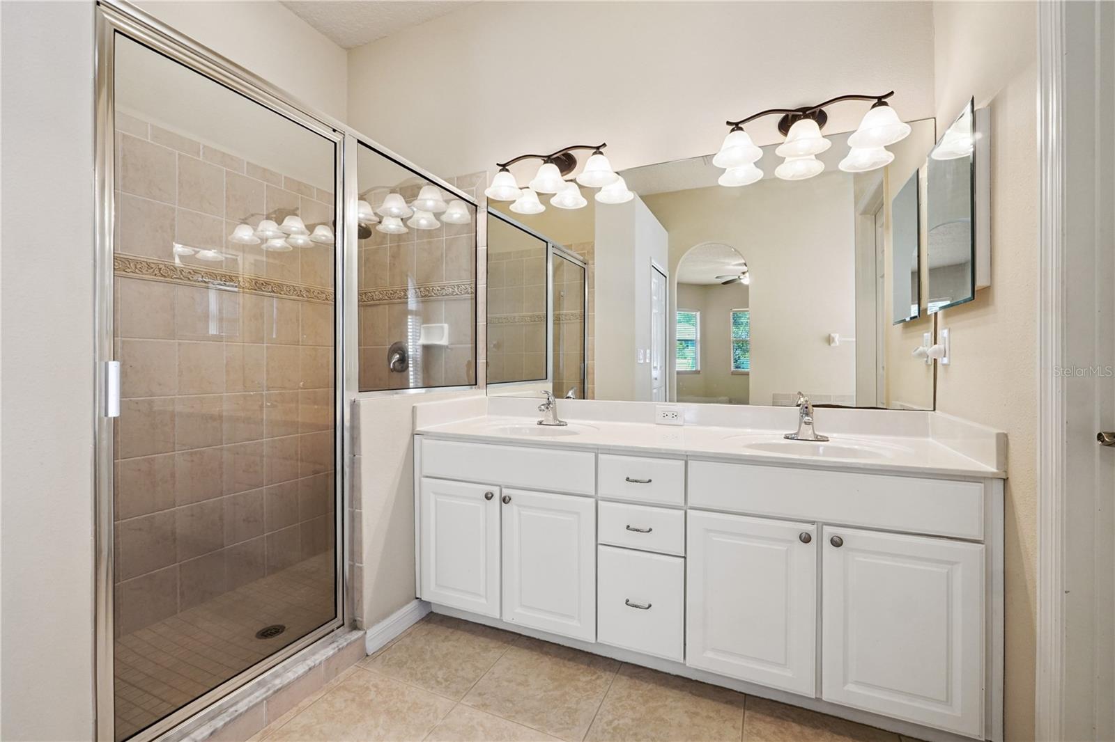 Primary bathroom with dual sink vanity and stand-up shower