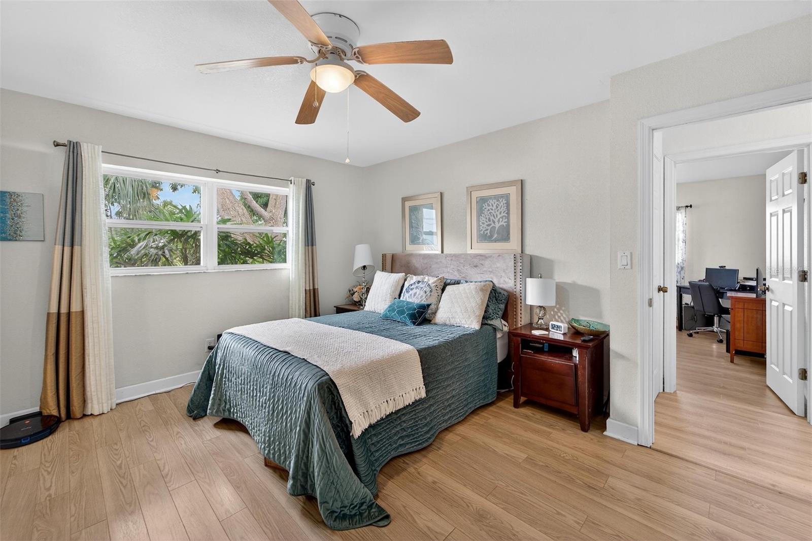 Primary Bedroom - Natural light filters through large windows, offering serene yard views and creating a peaceful retreat