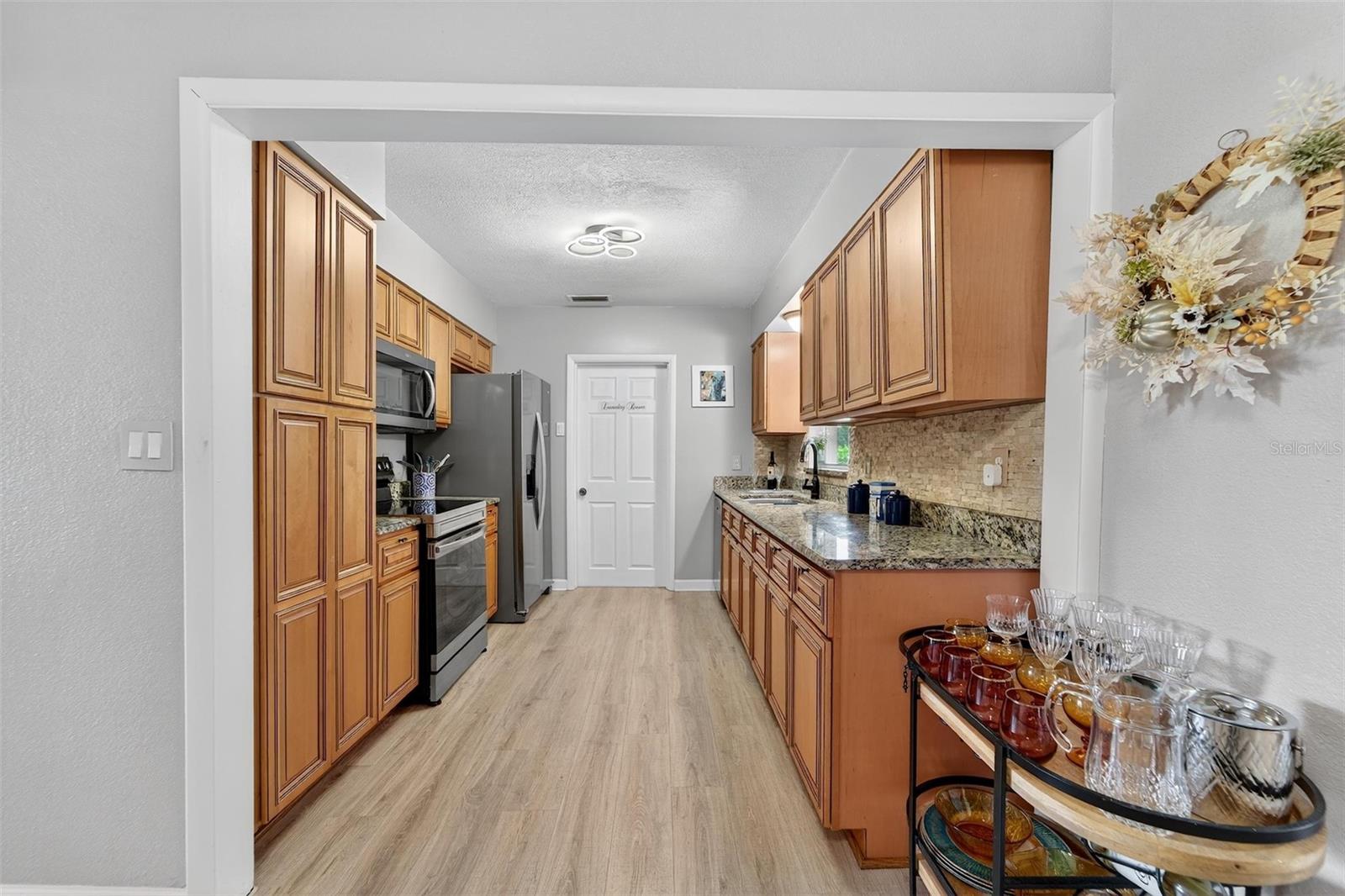 Bright and functional kitchen with beautiful laminate flooring and plenty of prep space