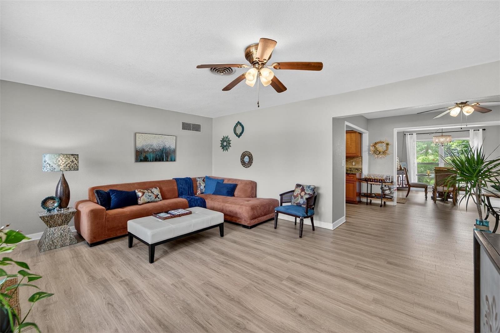 Step into a bright, open living room with beautiful floors and neutral tones