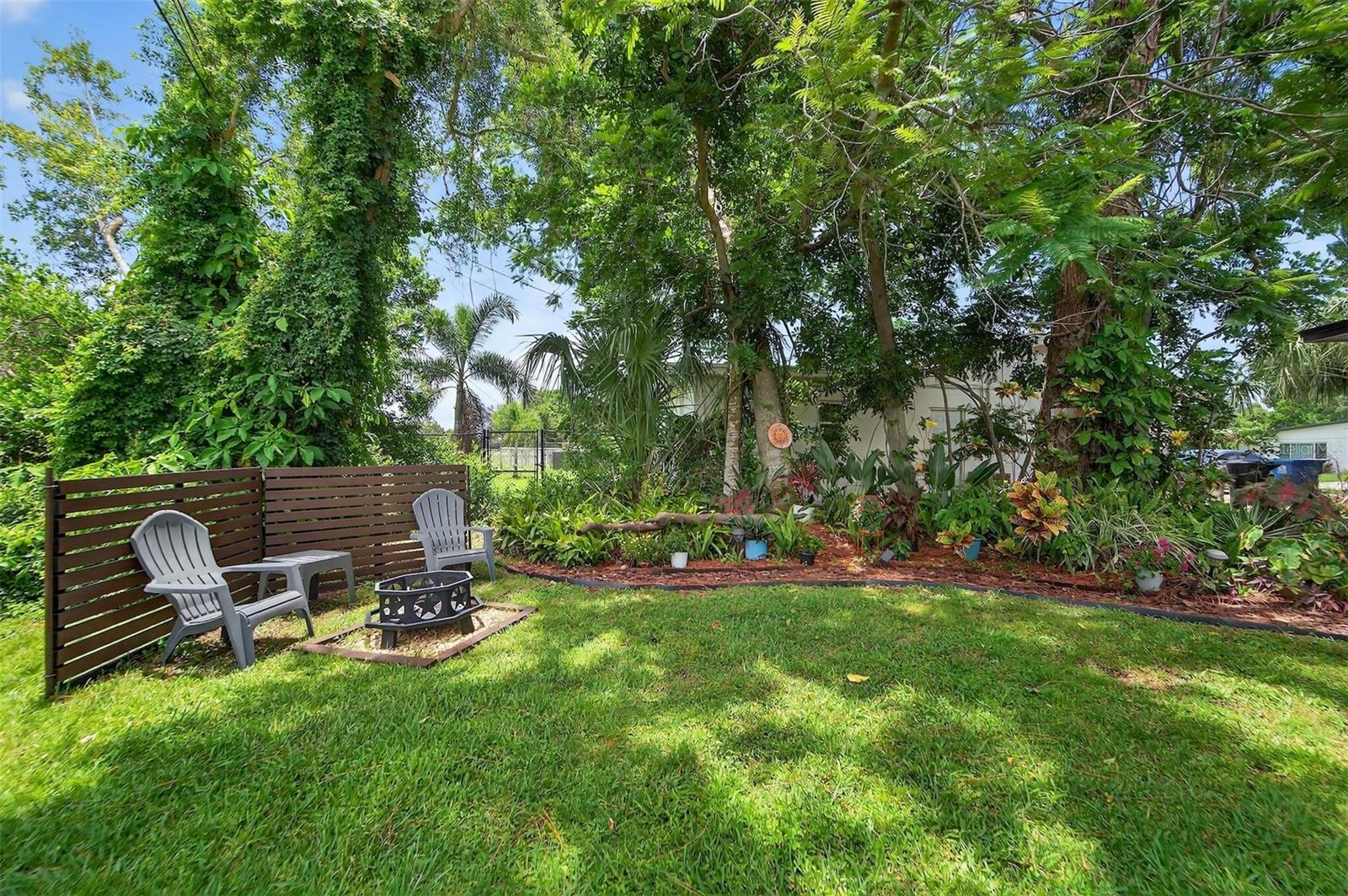Backyard - Nearly 9,705?sq?ft lot with lush landscaping, irrigation system, and fire pit area