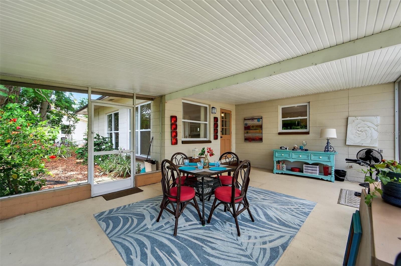 Relaxing screened lanai with tile flooring and plenty of space for outdoor dining or lounging—perfect for enjoying Florida’s weather year-round