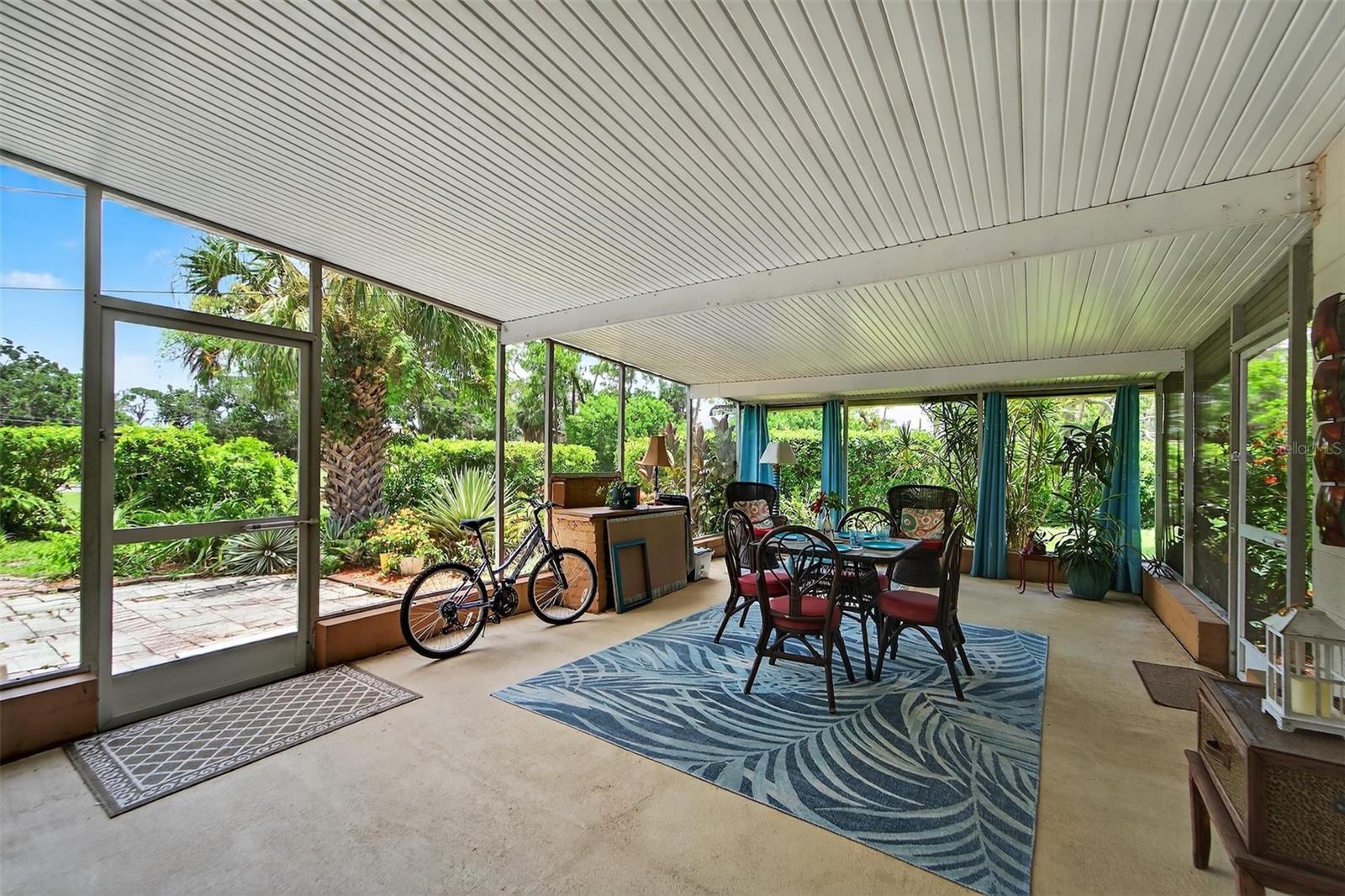 Inviting screened lanai—perfect for comfortable outdoor living in any season.  A place to enjoy your morning coffee or evening glass of wine