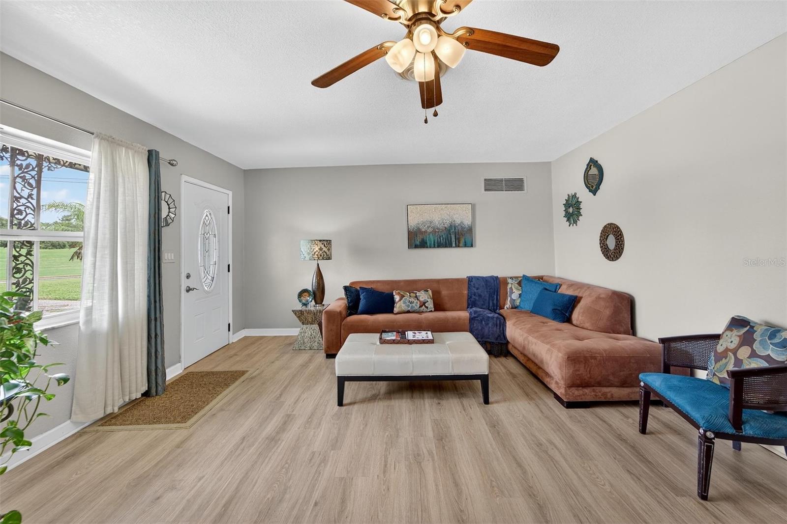 Living Room - Sunlight filled area creating a welcoming atmosphere perfect for family time or entertaining guests