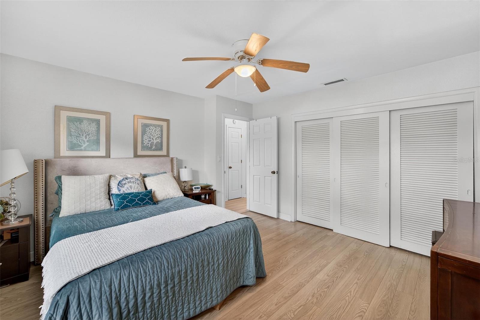 Primary Bedroom - Spacious and restful, this bedroom features neutral-toned walls, ceiling fan and a built-in closet