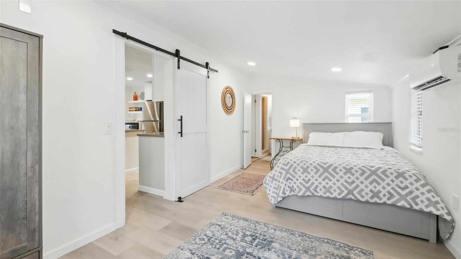 Front unit large bedroom with barn door