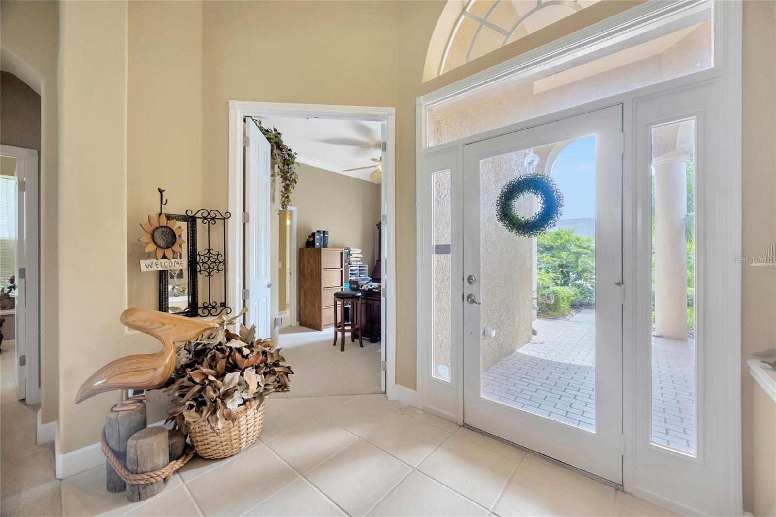 Entry with office through the open door in the center of photo